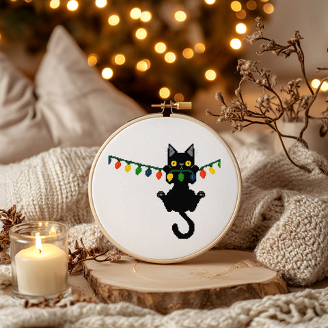 Christmas Black Cat Hanging from Lights Counted Cross Stitch Pattern