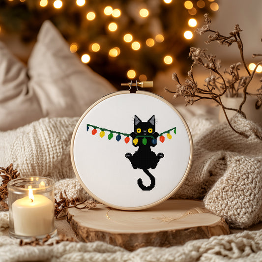 Christmas Black Cat Hanging from Lights Counted Cross Stitch Pattern